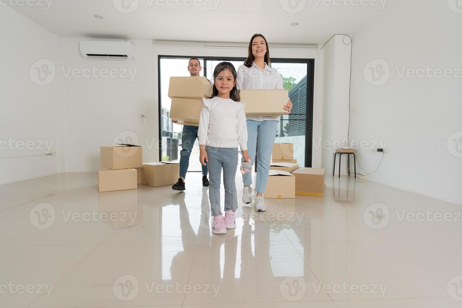 Happy family with girl moving into a new home. photo