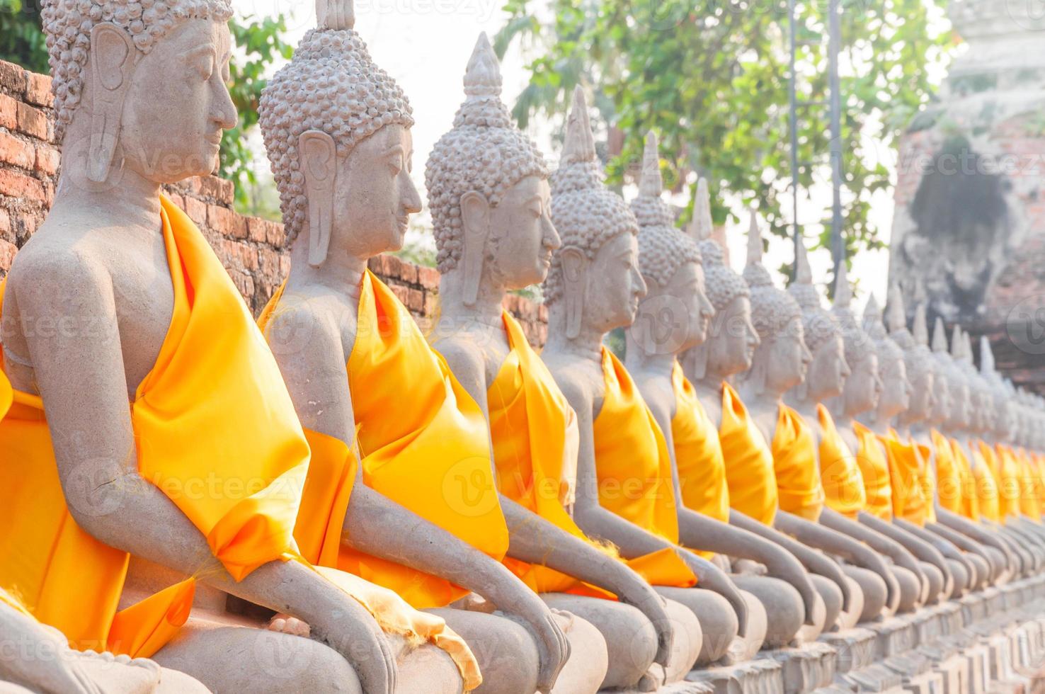Buddha statues in at Wat Yai Chaimongkol in Ayutthaya Thailand, in Ayutthaya historical park, which is recognized as a unesco world heritage site photo