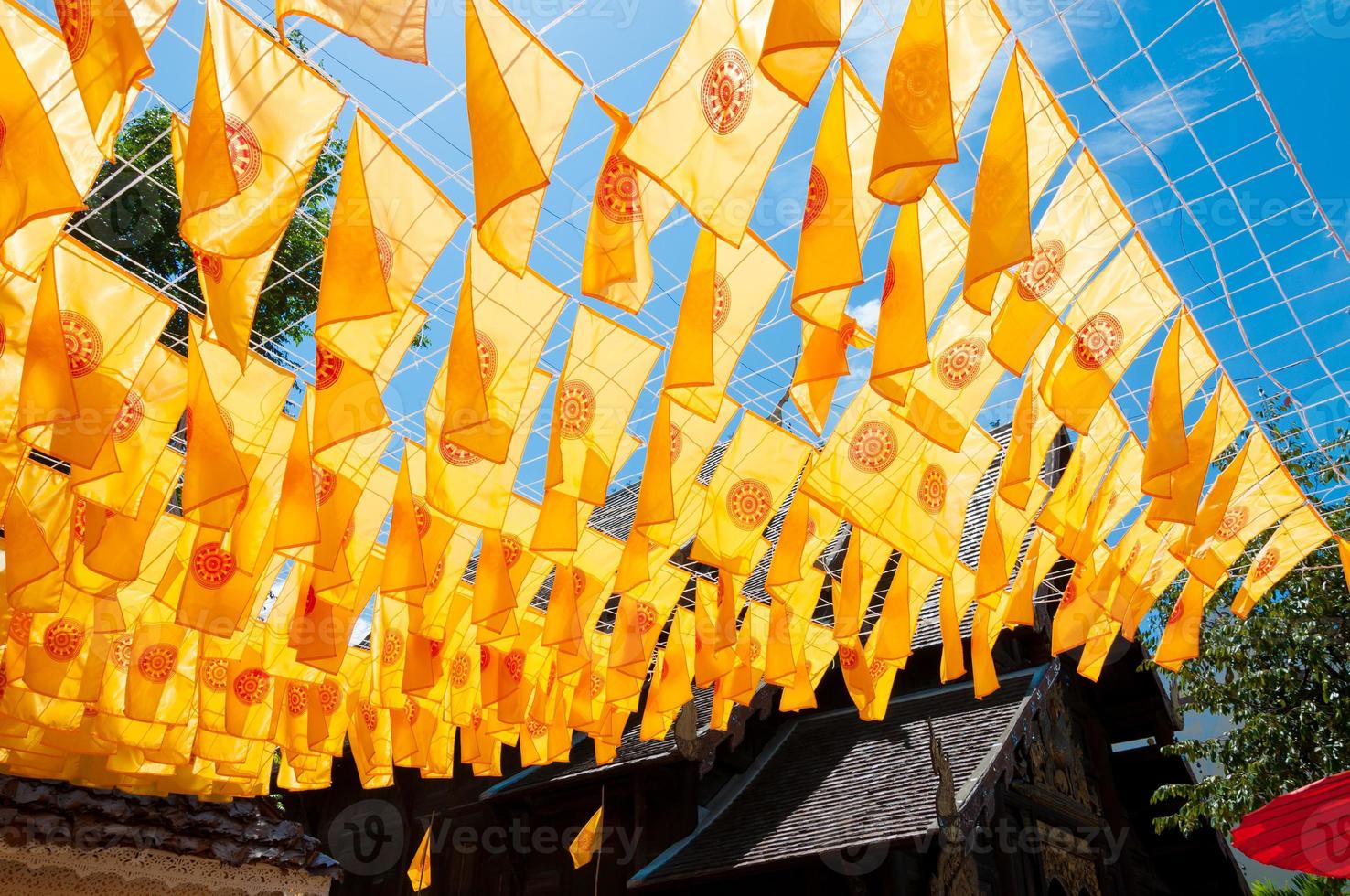 Thammachak flag yellow in temple Wat Phan tao on blue sky temple Northern Thailand photo