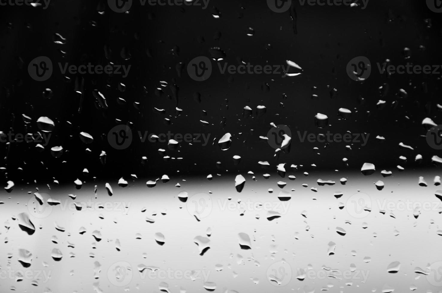 Water drops on glass texture abstract black dark background,Selective focus photo