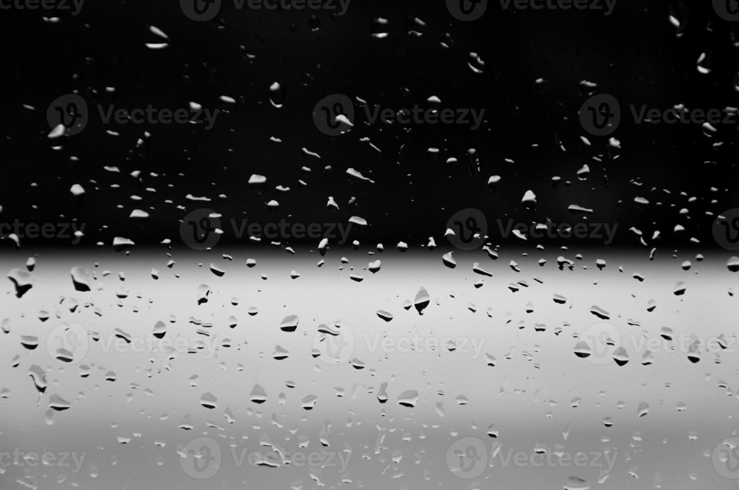 Water drops on glass texture abstract black dark background,Selective focus photo