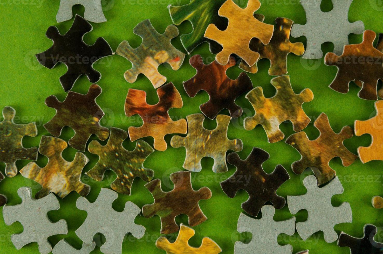 Puzzle on green background photo