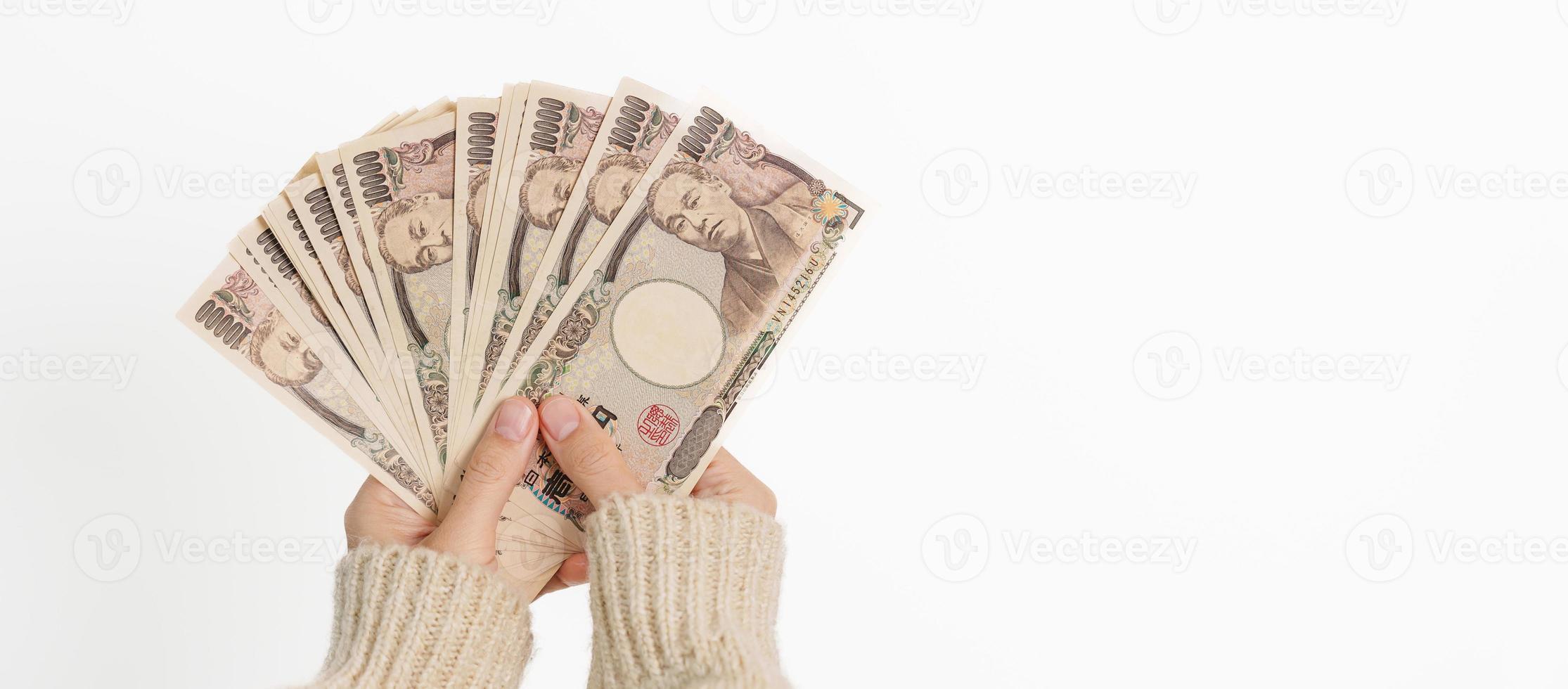 Woman hand holding Japanese Yen banknote stack. Thousand Yen money. Japan cash, Tax, Recession Economy, Inflation, Investment, finance and shopping payment concepts photo