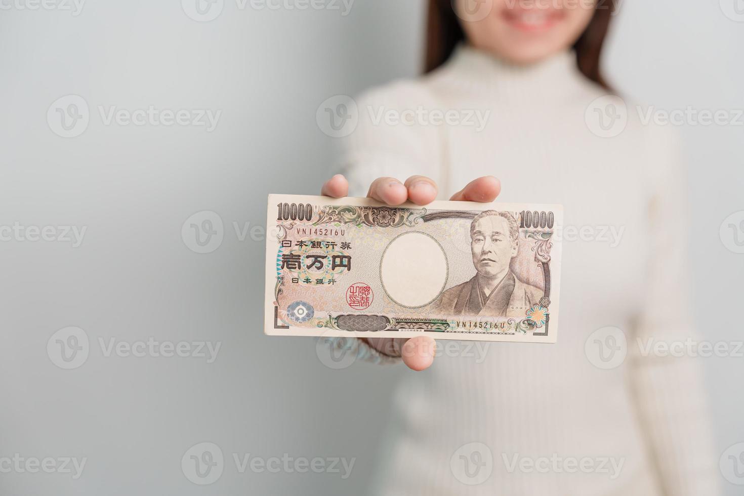 Woman hand holding Japanese Yen banknote stack. Thousand Yen money. Japan cash, Tax, Recession Economy, Inflation, Investment, finance and shopping payment concepts photo