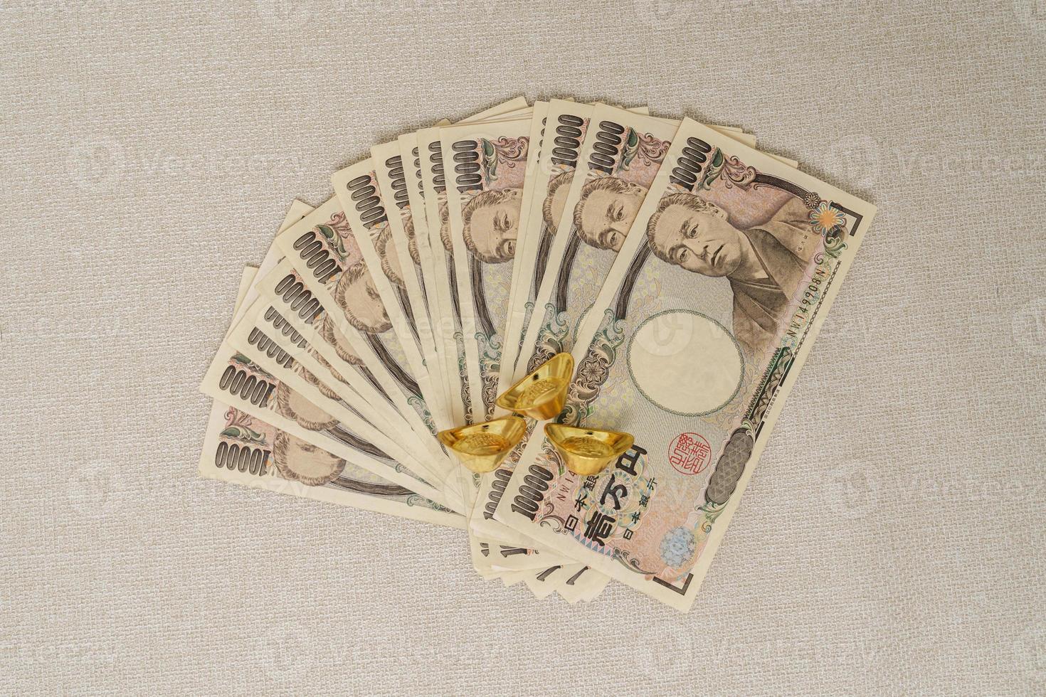 Japanese Yen Banknote Stack And Gold Bullion Thousand Yen Money Japan japanese-yen-banknote-stack-and-gold-bullion-thousand-yen-money-japan