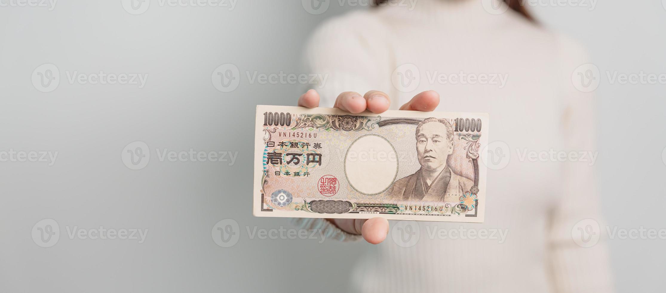 Woman hand holding Japanese Yen banknote stack. Thousand Yen money. Japan cash, Tax, Recession Economy, Inflation, Investment, finance and shopping payment concepts photo