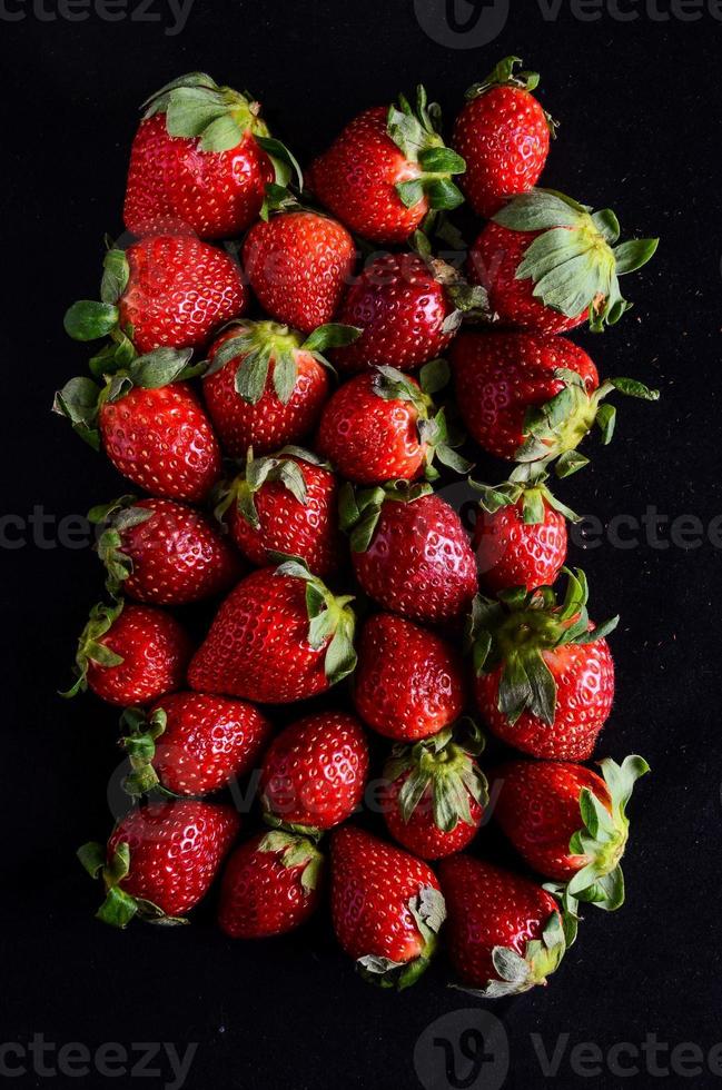 Strawberries on black background photo