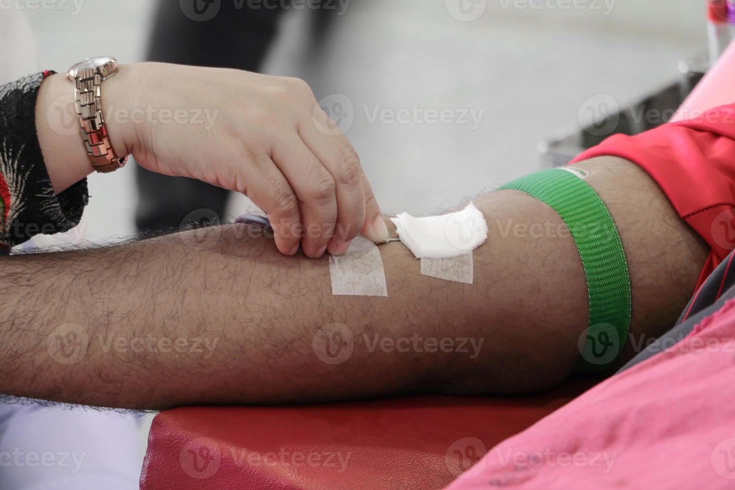 Blood donor in arm injection select focus with shallow depth of field. photo