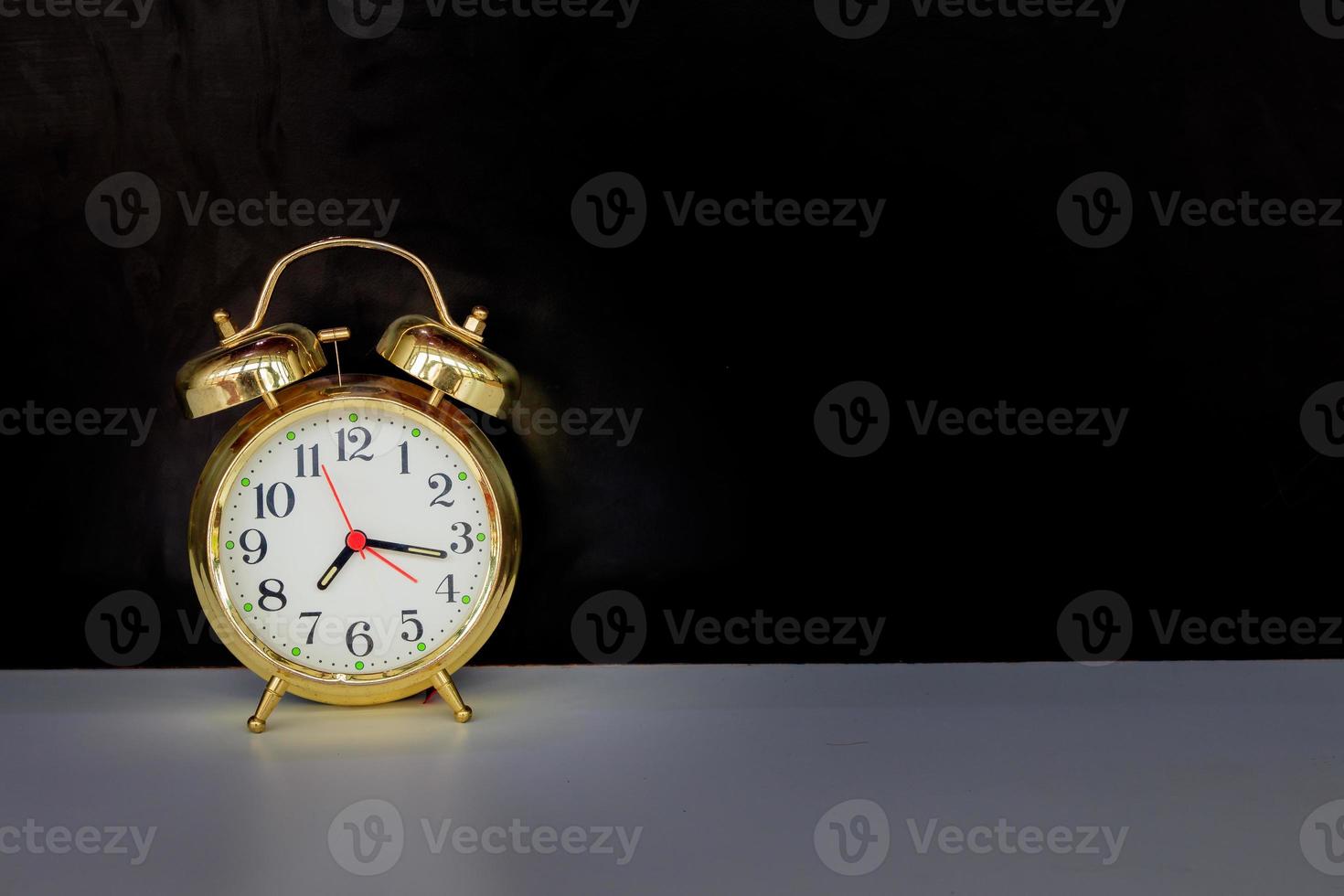 alarm clock old vintage gold on white and black background with copy space add text retro style photo
