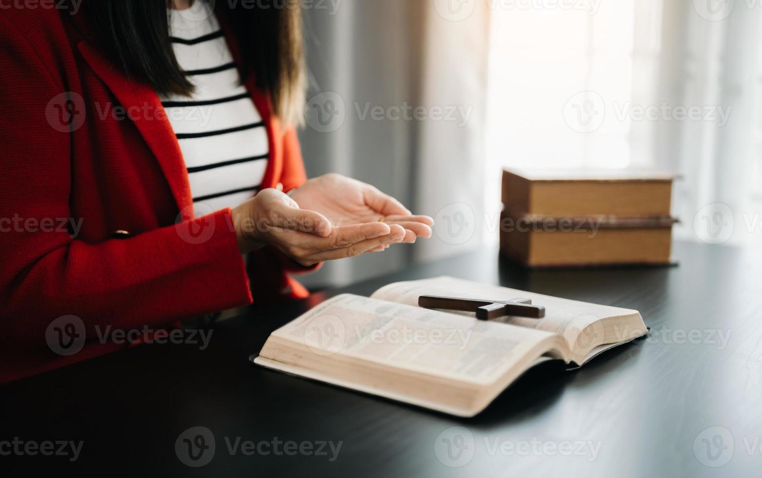 Woman praying on holy bible in the morning.Woman hand with Bible praying. Christian life crisis prayer to god. photo