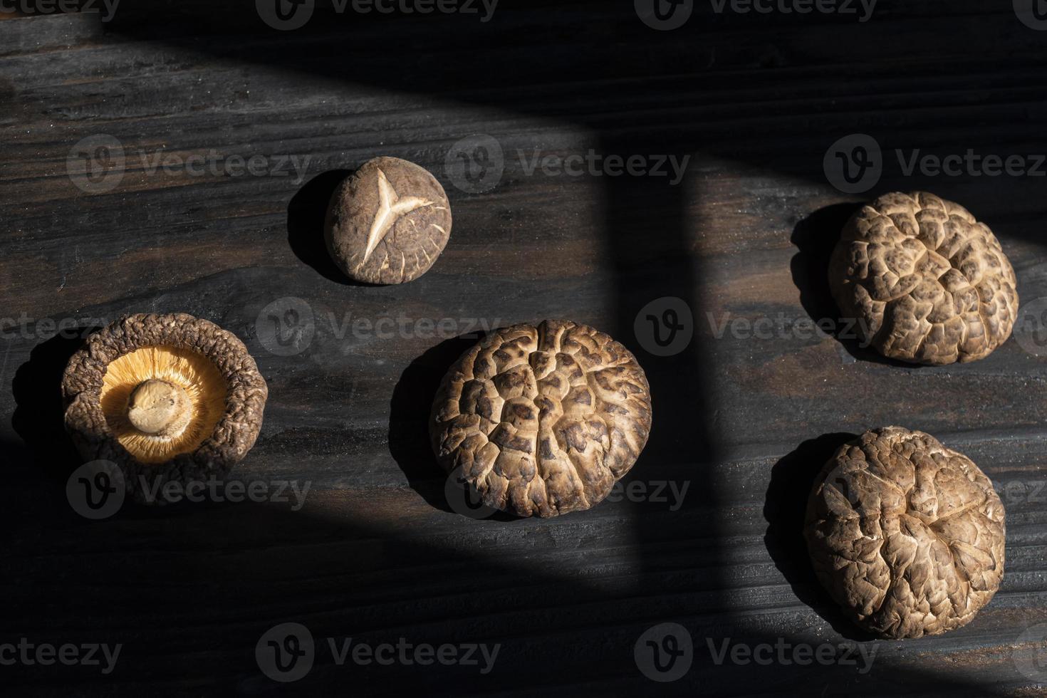 Dry Shiitake mushroom on dark wood table. photo