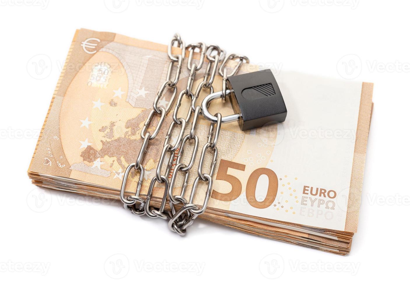 Lock security and chain on euro stack banknotes isolated on white background. Monetary crisis, financial problems, default concept photo