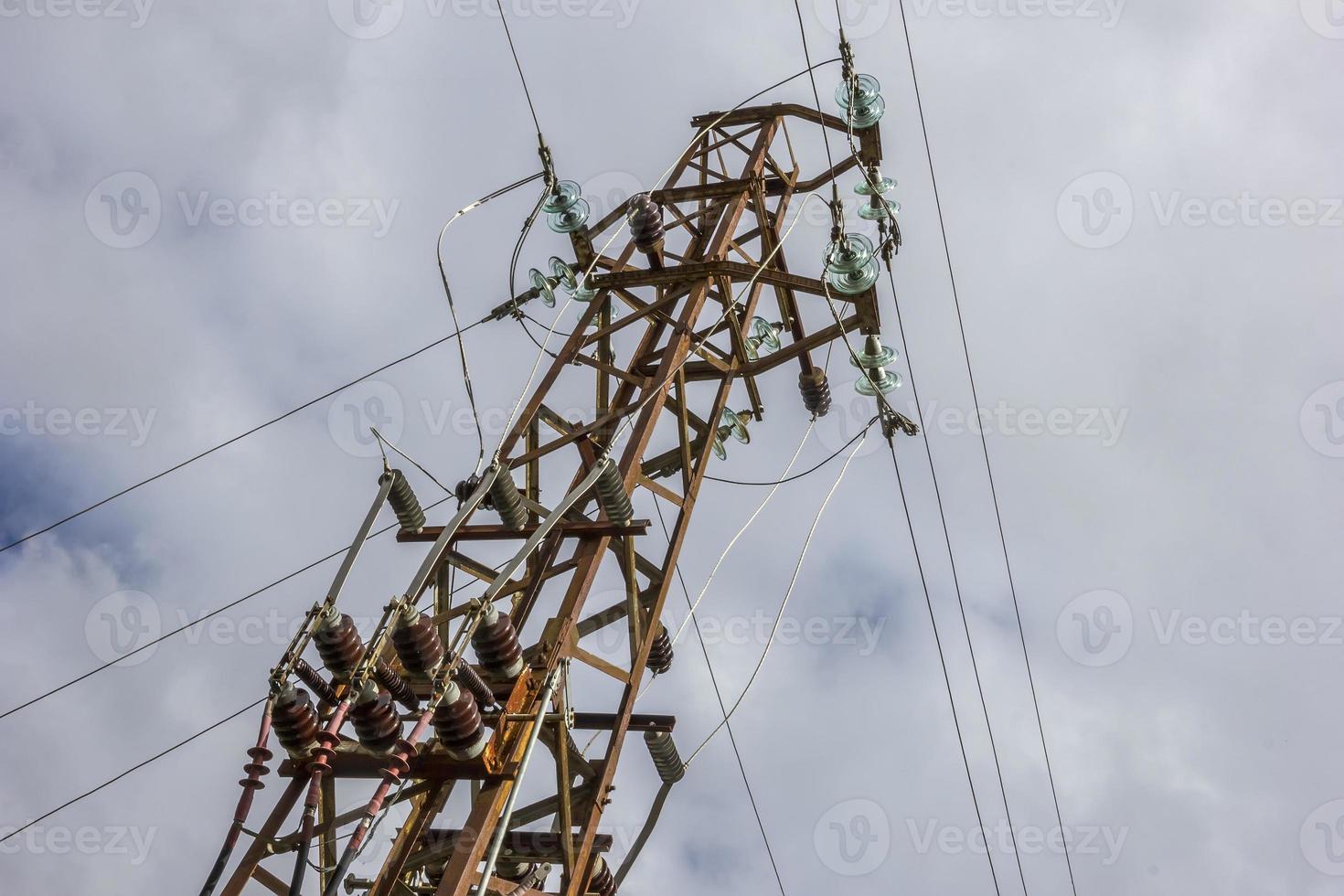 High voltage electric pole and transmission lines. Electricity pylons. Power and energy engineering system. Cable wire on an electric post. photo