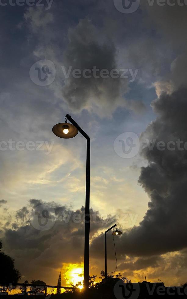 silhouette of lights against a background of clouds and sunset photo