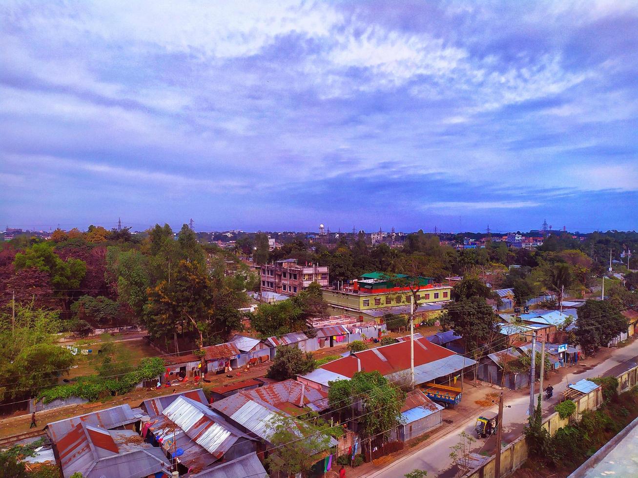 Aerial view of the city of Rangpur. Panorama of a town. Landscape scene in Bangladesh.Urban environment landscape with many green trees. Architectural view of the coast of the resort town photo