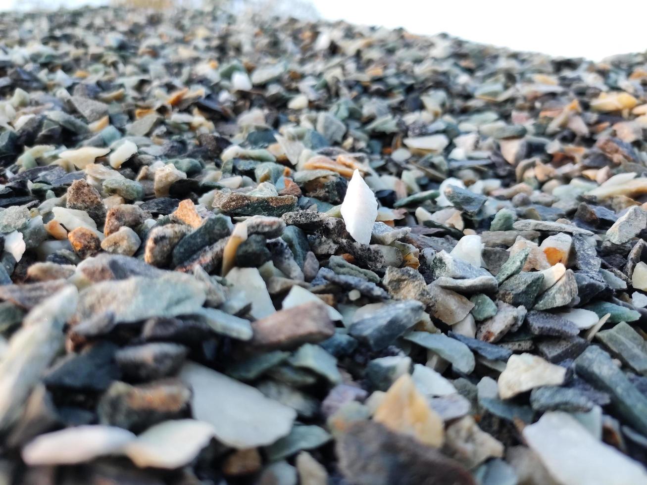 Stack of broken stones.Big pile of broken Rocks and Boulders.Pile stack of huge natural granite stone.Stack of Crushed Stones in quarry. Colorful pebble. photo