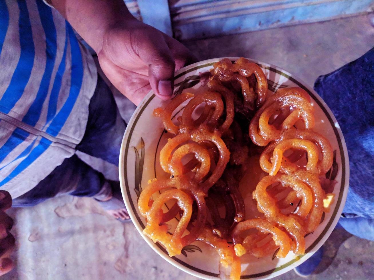Jalebi is ready to eat.Plate filling Jalebi. jilapi is a Favorite fast food or Snack food in Bangladesh and India.It is made in a mixture of sugar and flour. photo