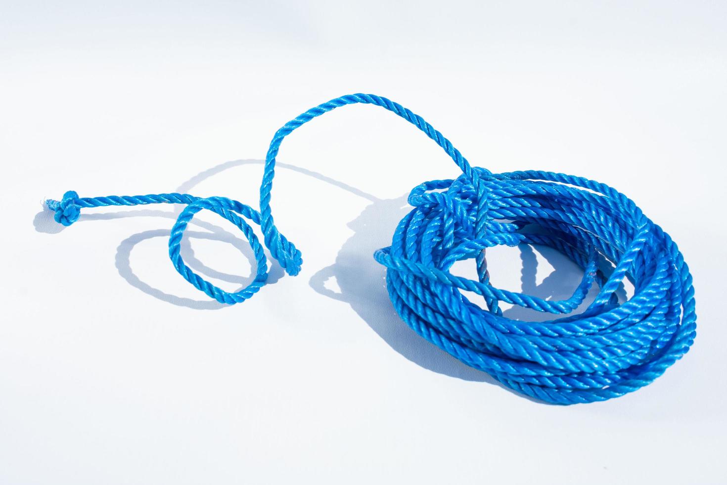 Close up view of blue rope isolated on white background photo
