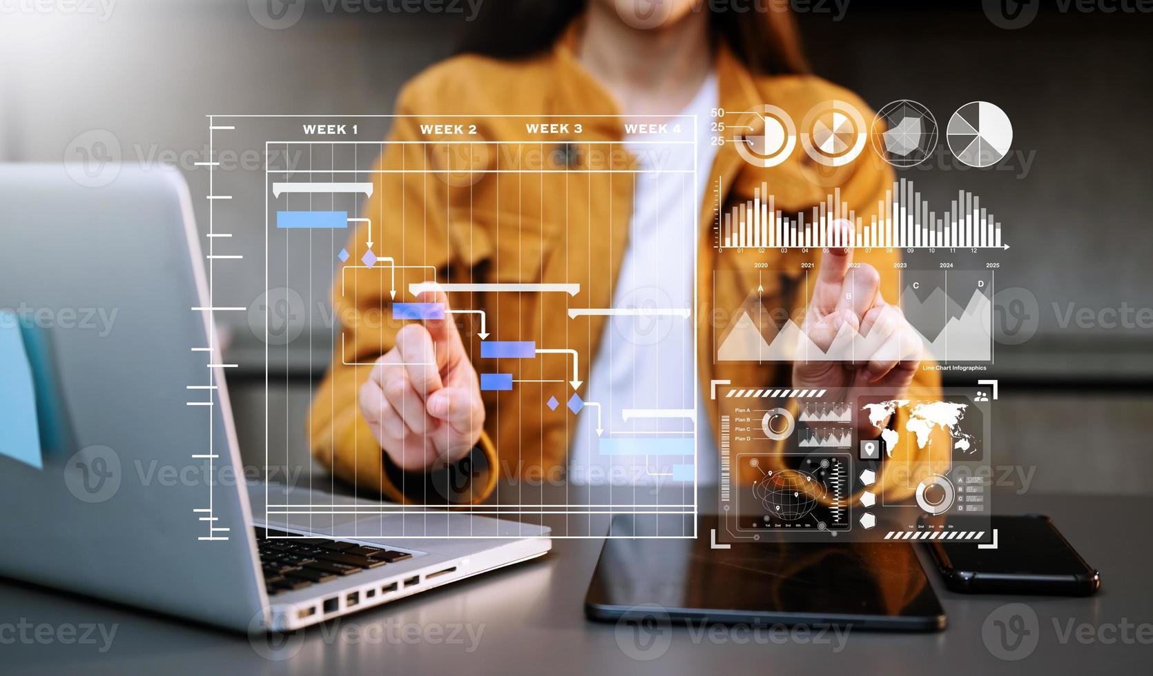 Businessman hand Project manager working and update tasks and Gantt chart scheduling virtual diagram.with smart phone, tablet and laptop in office. photo
