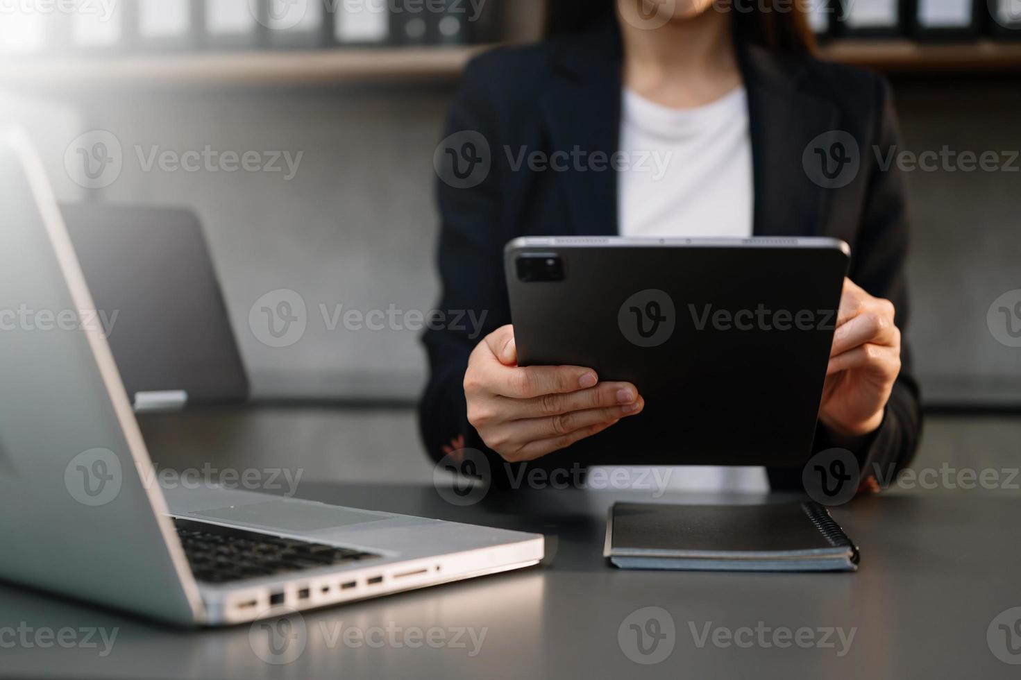 businesswoman hand using smart phone, tablet payments and holding credit card online shopping, omni channel, digital tablet docking keyboard computer at office photo