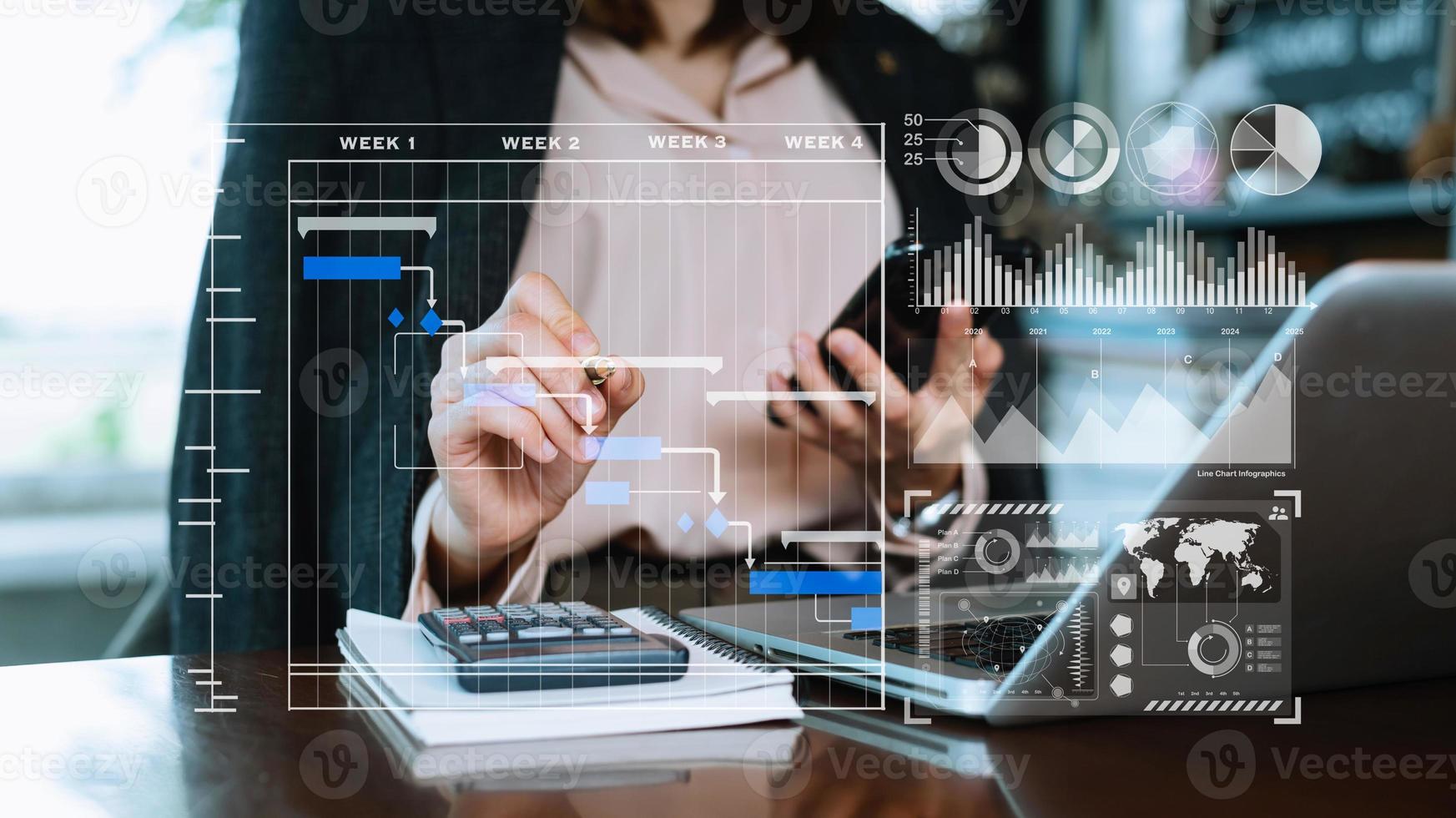 Businessman hand Project manager working and update tasks and Gantt chart scheduling virtual diagram.with smart phone, tablet and laptop in office. photo
