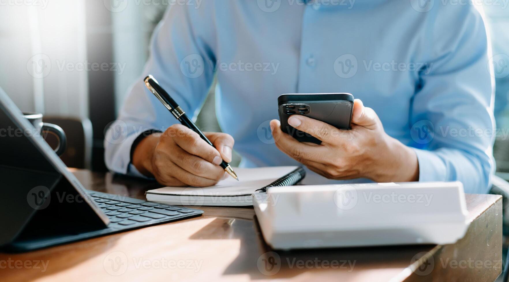 businessman hand working with new modern computer and writing on the notepad strategy diagram as concept morning light photo