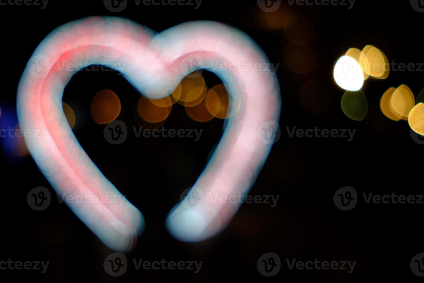 Abstract White Bokeh in the Heart Shape Background for Valentine Concept. photo