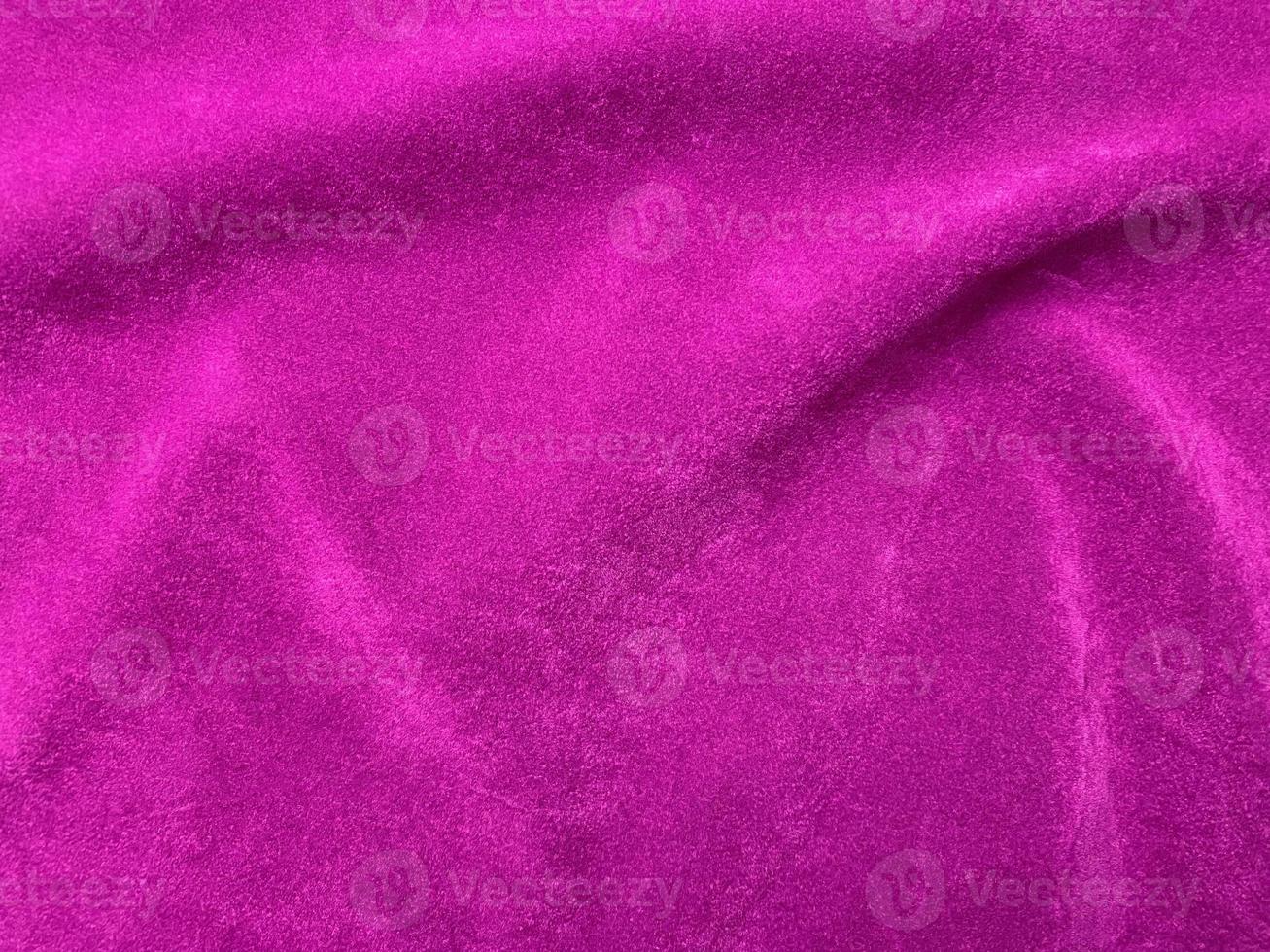 Pink velvet fabric texture used as background. Empty pink fabric