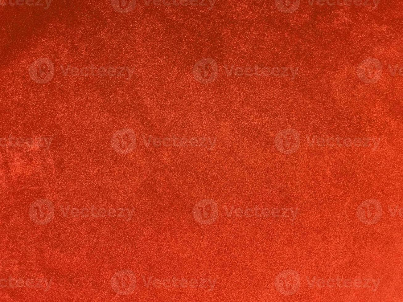 textura de tela de terciopelo naranja utilizada como fondo. fondo de tela naranja vacío de material textil suave y liso. hay espacio para el texto.. foto