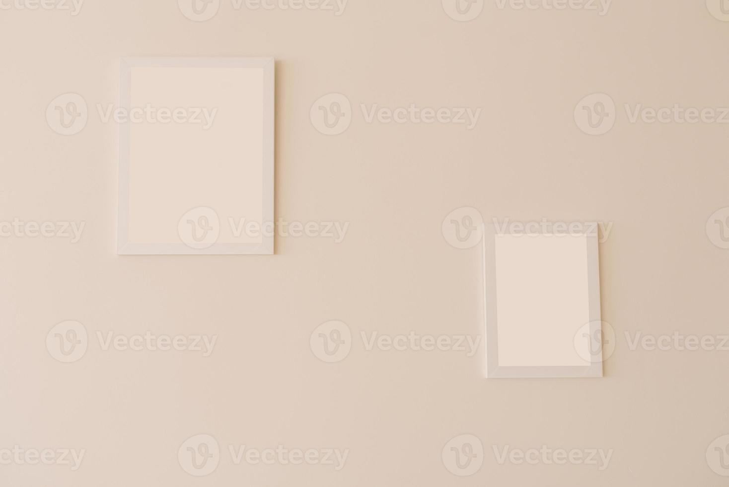 White mockup frames on a beige wall of different sizes photo