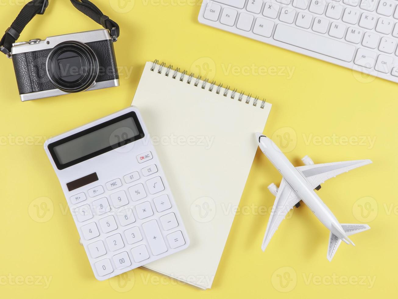flat lay of airplane model, computer keyboard, notebook