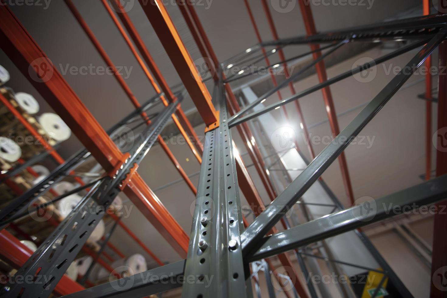 Warehouse premises of a factory or workshop with metal shelves. photo