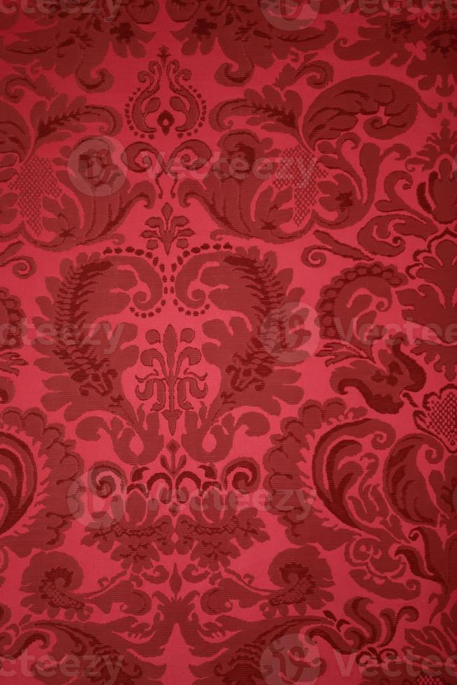 An old pattern on tapestry fabric.Vintage retro background red. photo