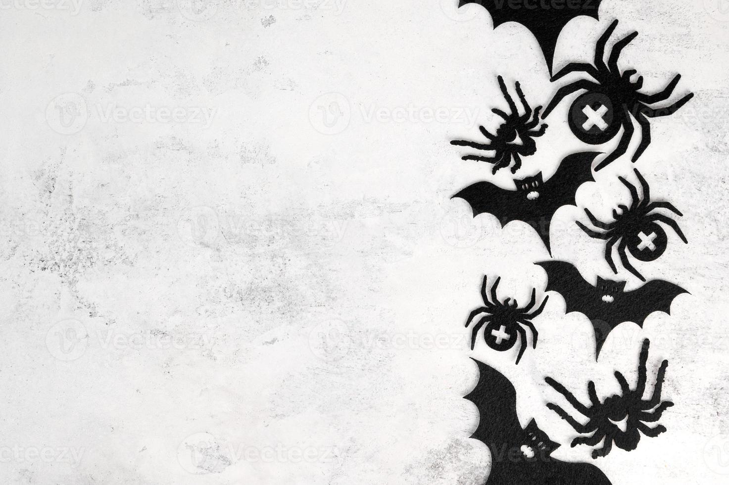 Top view on halloween decorations.Spiders and bats on white concrete with copy space. October 31 concept photo