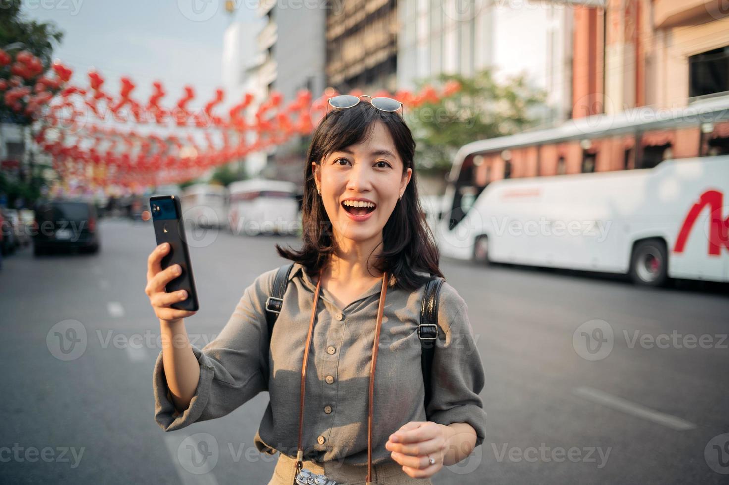 Young Asian woman backpack traveler enjoying China town street food market in Bangkok, Thailand. Traveler checking out side streets. photo