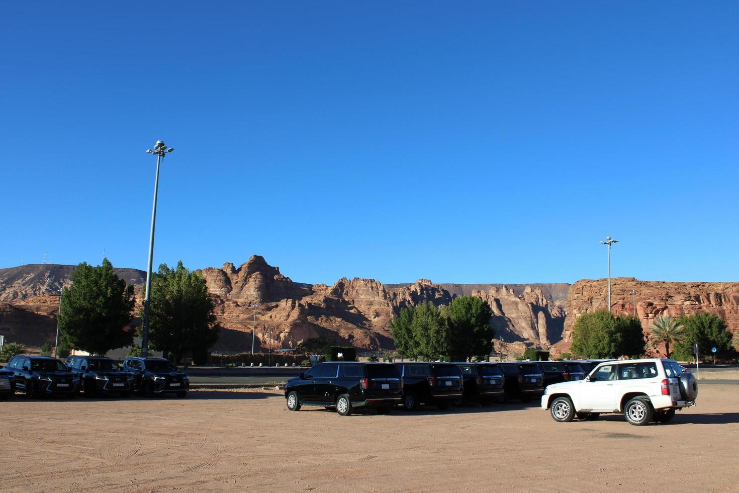 Al Ula, Saudi Arabia, March 2023 - Jeeps are parked at different places in the desert to take tourists to different places during the day in Al Ula, Saudi Arabia. photo