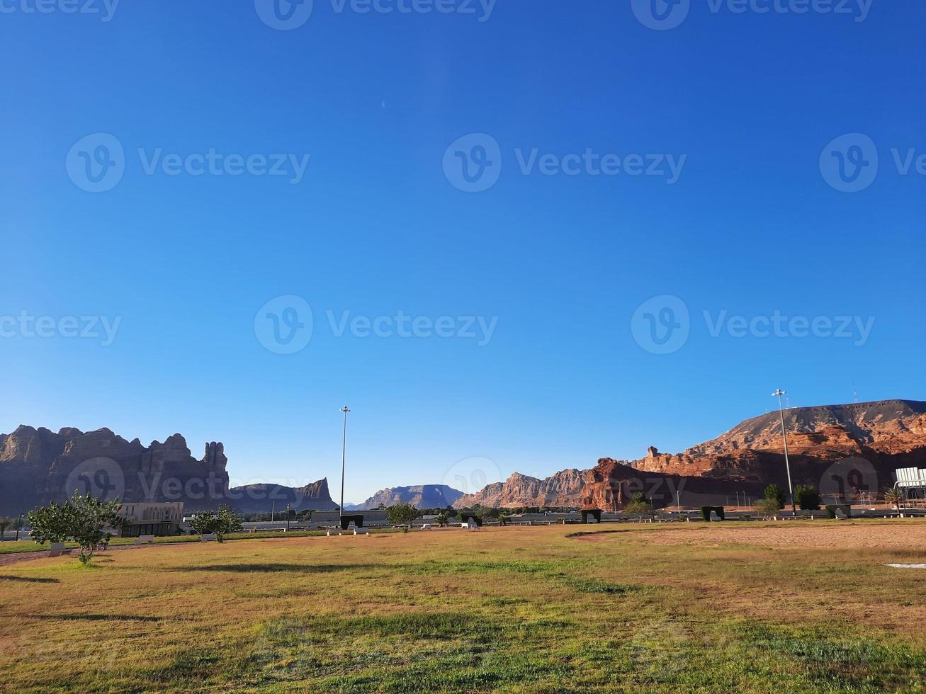 A beautiful daytime view of a winter park in Al Ula, Saudi Arabia. The park is surrounded by ancient hills. photo