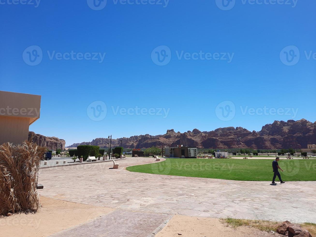 A beautiful daytime view of a winter park in Al Ula, Saudi Arabia. The park is surrounded by ancient hills. photo