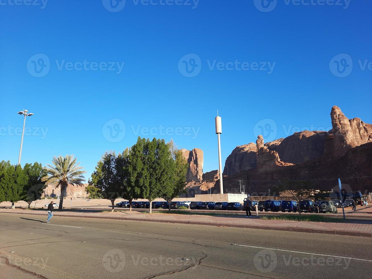 A beautiful daytime view of a winter park in Al Ula, Saudi Arabia. The park is surrounded by ancient hills. photo