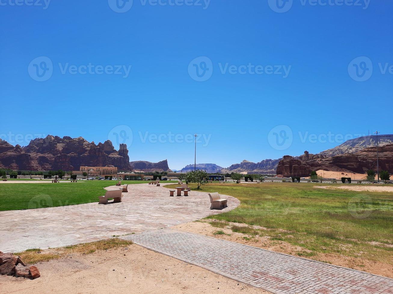 A beautiful daytime view of a winter park in Al Ula, Saudi Arabia. The park is surrounded by ancient hills. photo