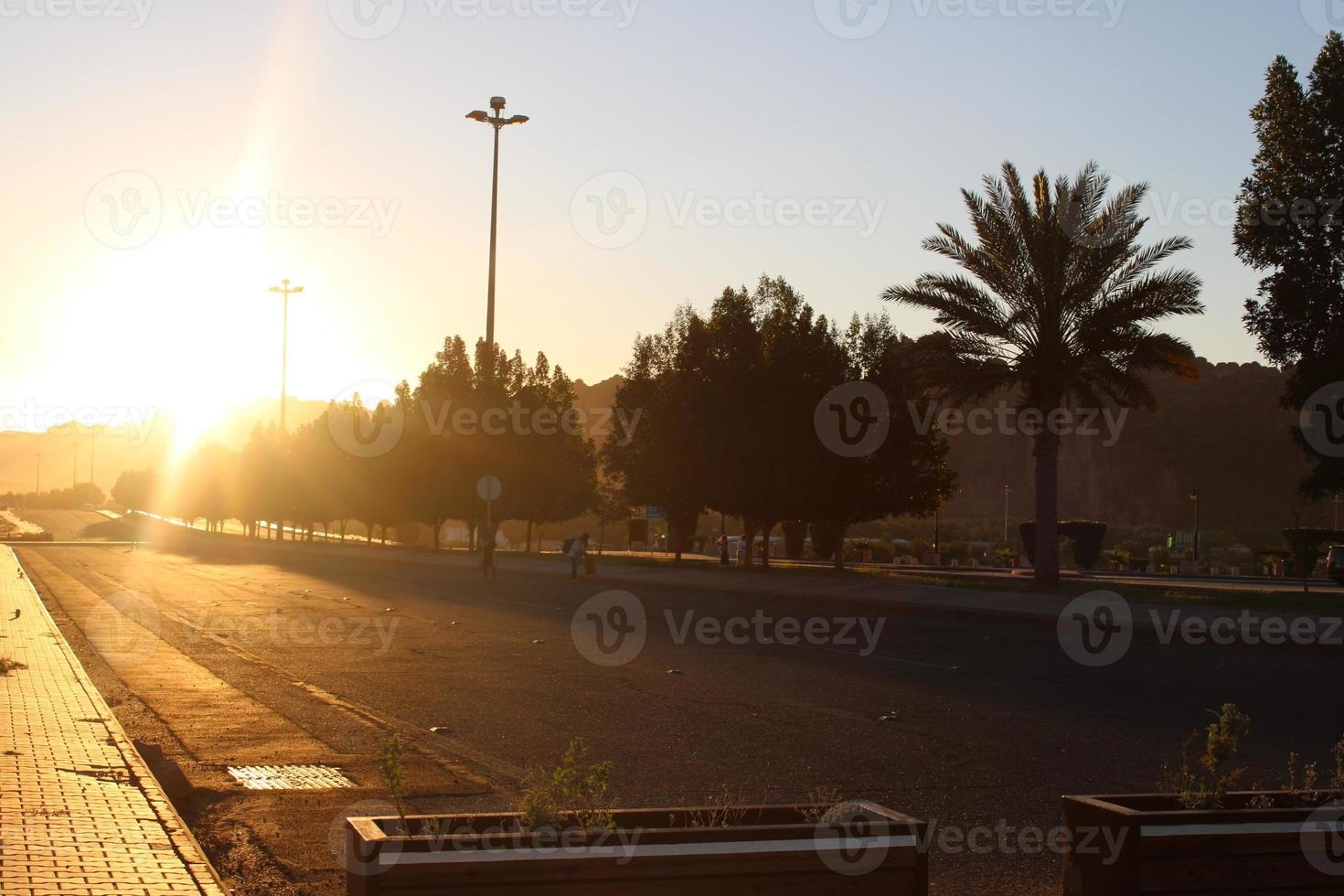 A beautiful daytime view of a winter park in Al Ula, Saudi Arabia. The park is surrounded by ancient hills. photo