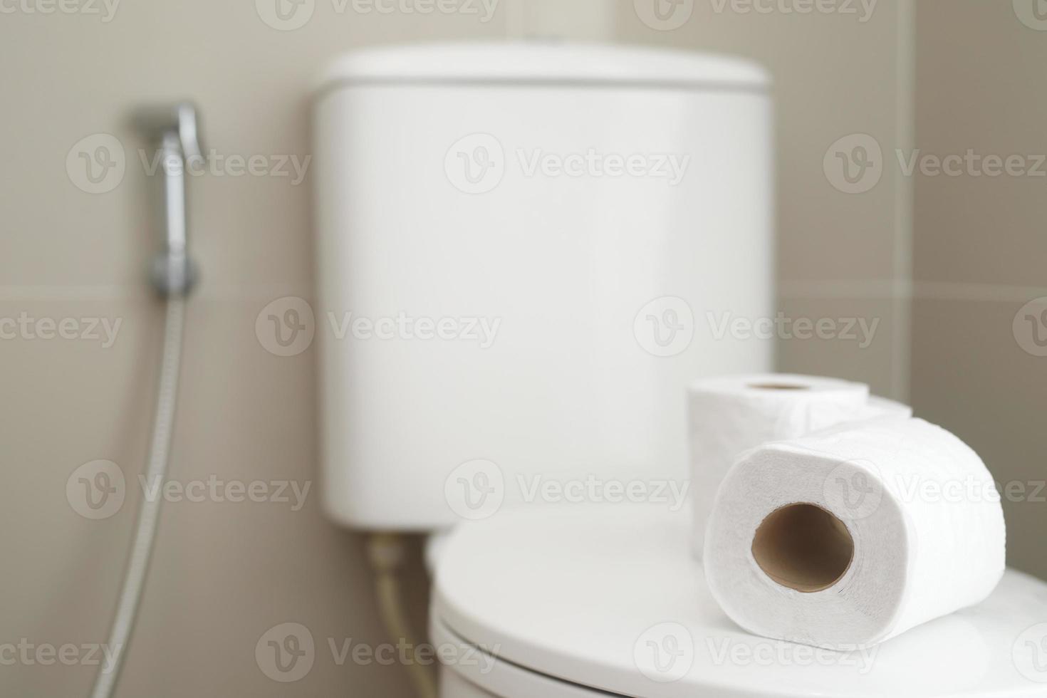 The tissue paper was placed on the toilet bowl in the bathroom. photo