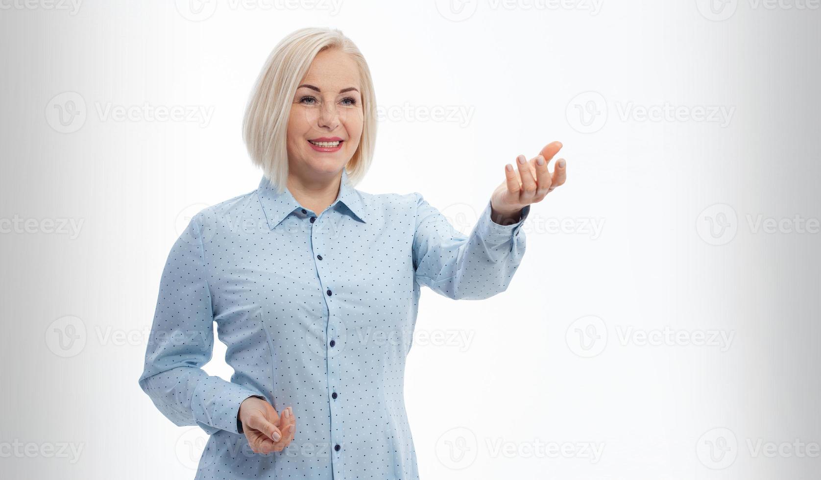 Business lady hold open hand new product open palm empty space sales manager wear specs shirt isolated grey background photo