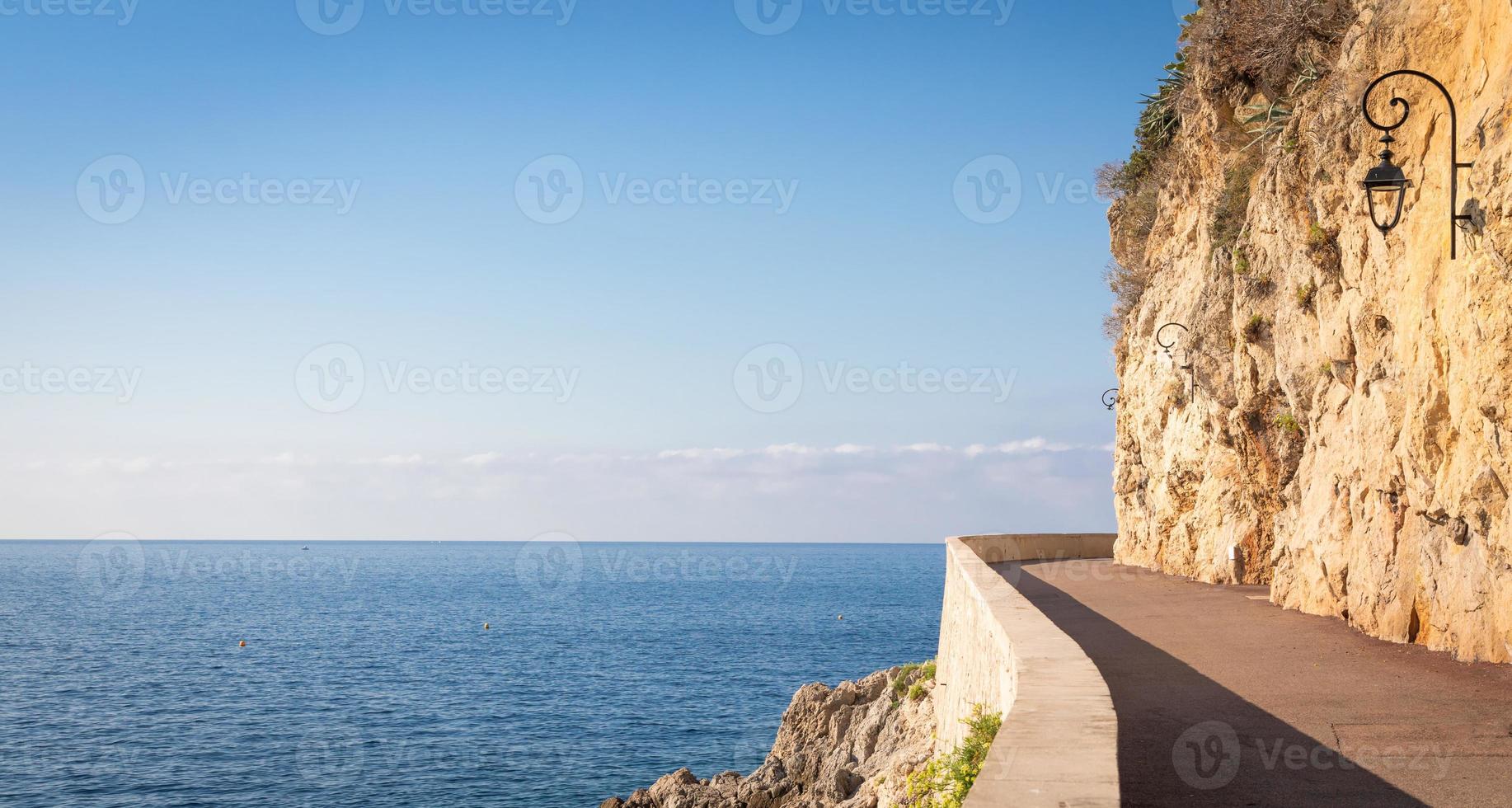 Promenade in front of the sea. Blue sky on scenery seascape. Concept of travel, adventure, freedom. photo