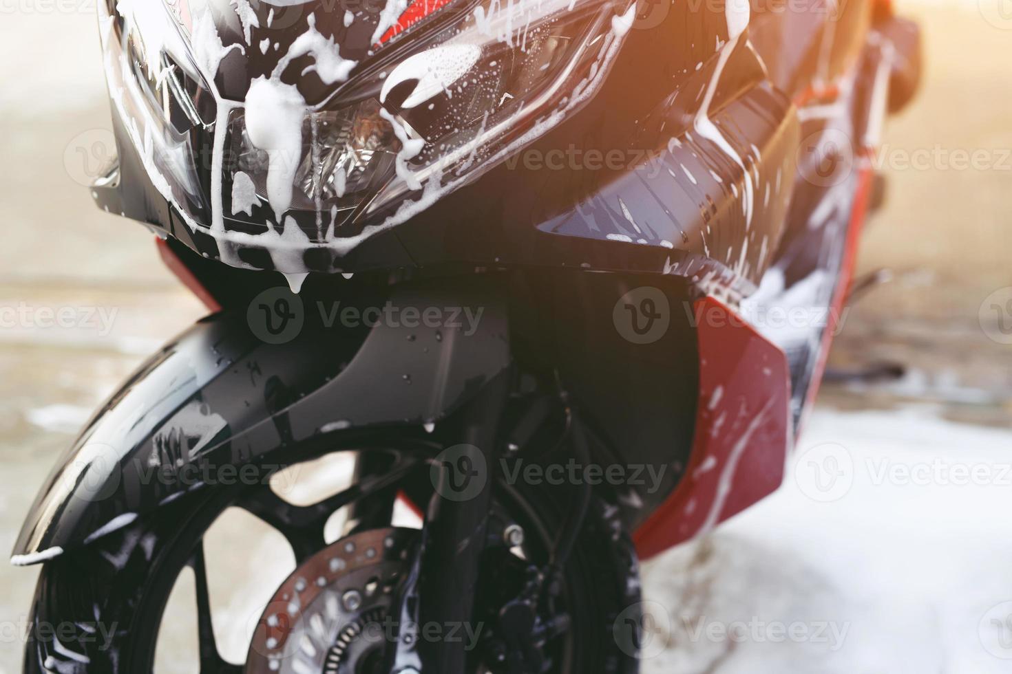 The worker is washing the motorcycle at Car Care. photo