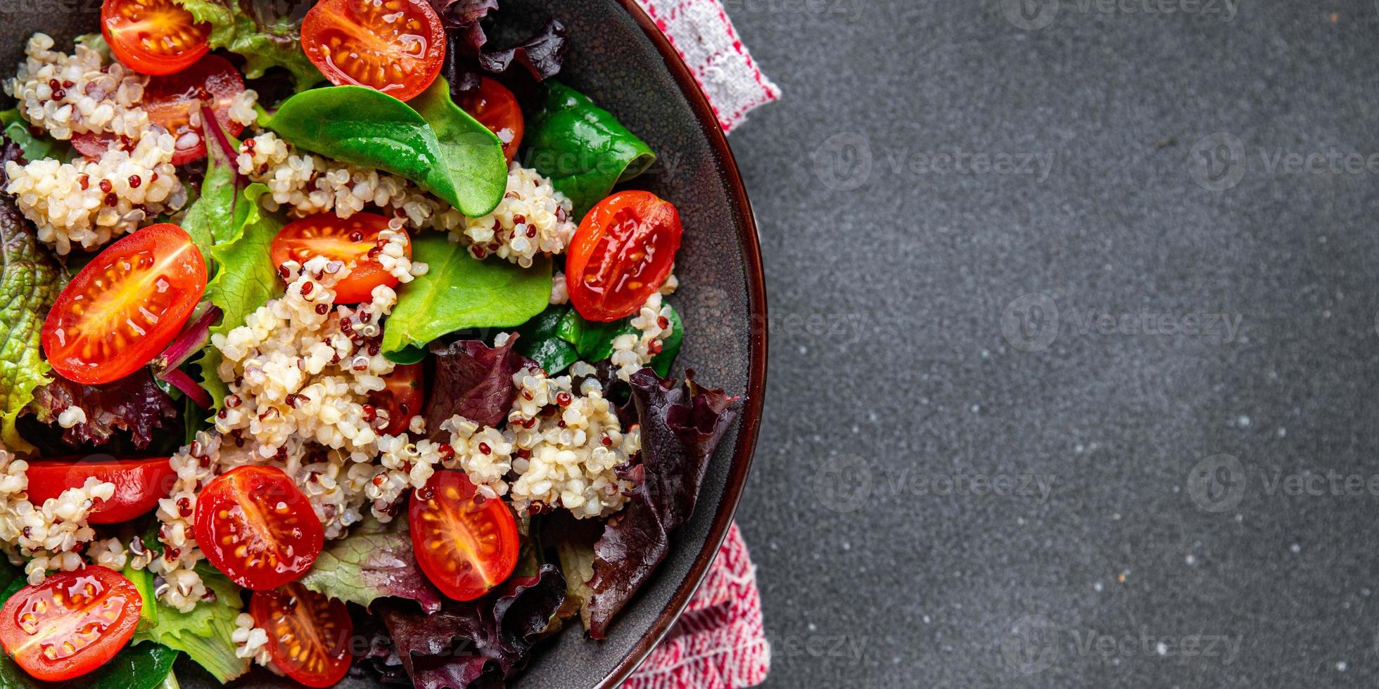 quinoa salad tomato, green leaf mix healthy meal food snack on the table copy space food background photo