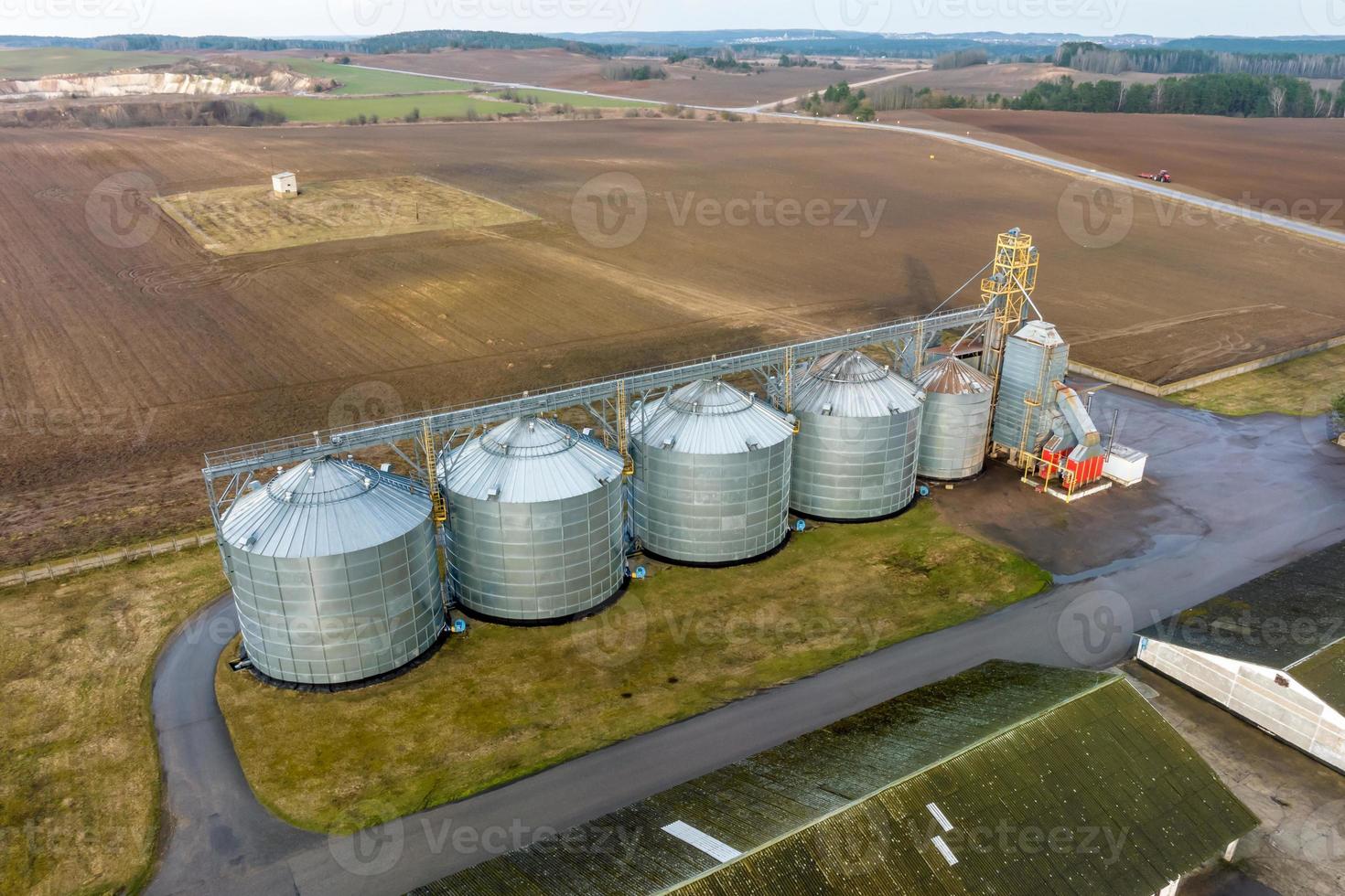 aerial panoramic view on agro-industrial complex with silos and grain drying line photo