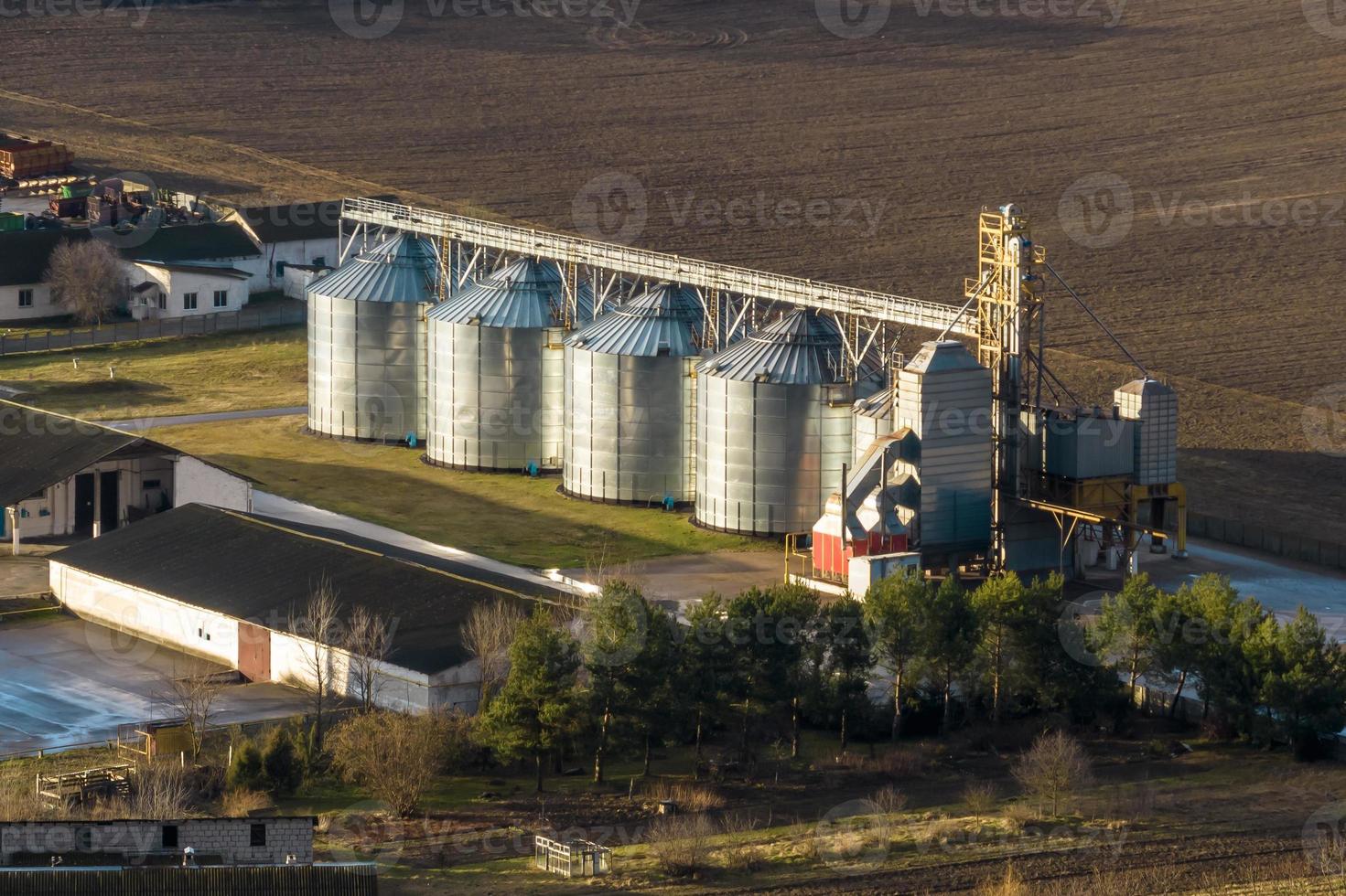 aerial panoramic view on agro-industrial complex with silos and grain drying line photo