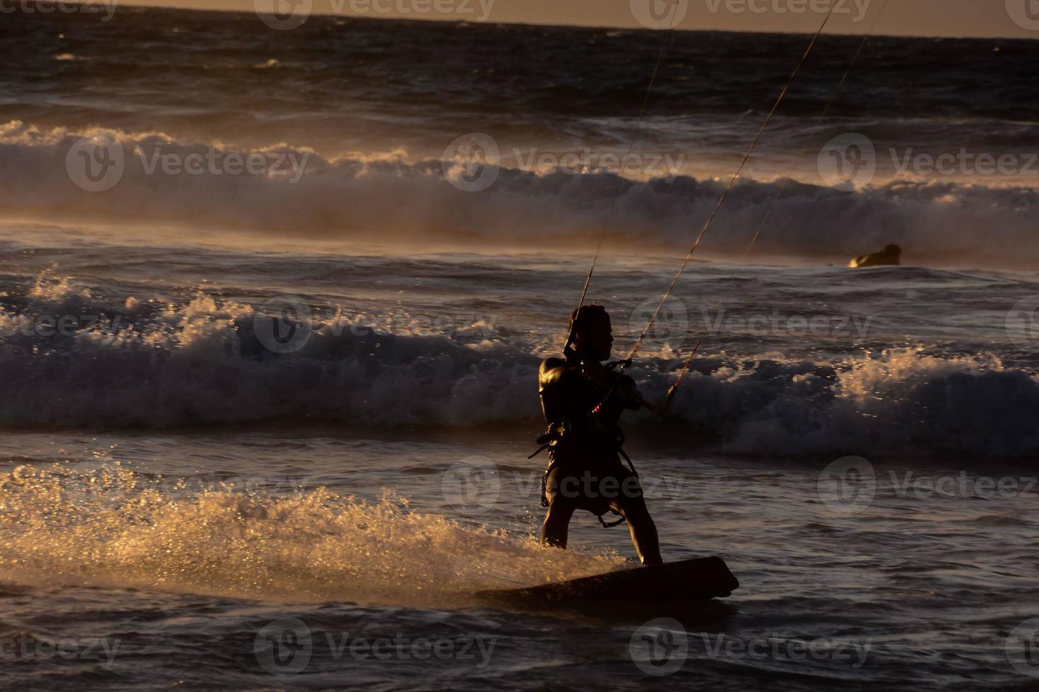 kitesurfer a puesta de sol foto