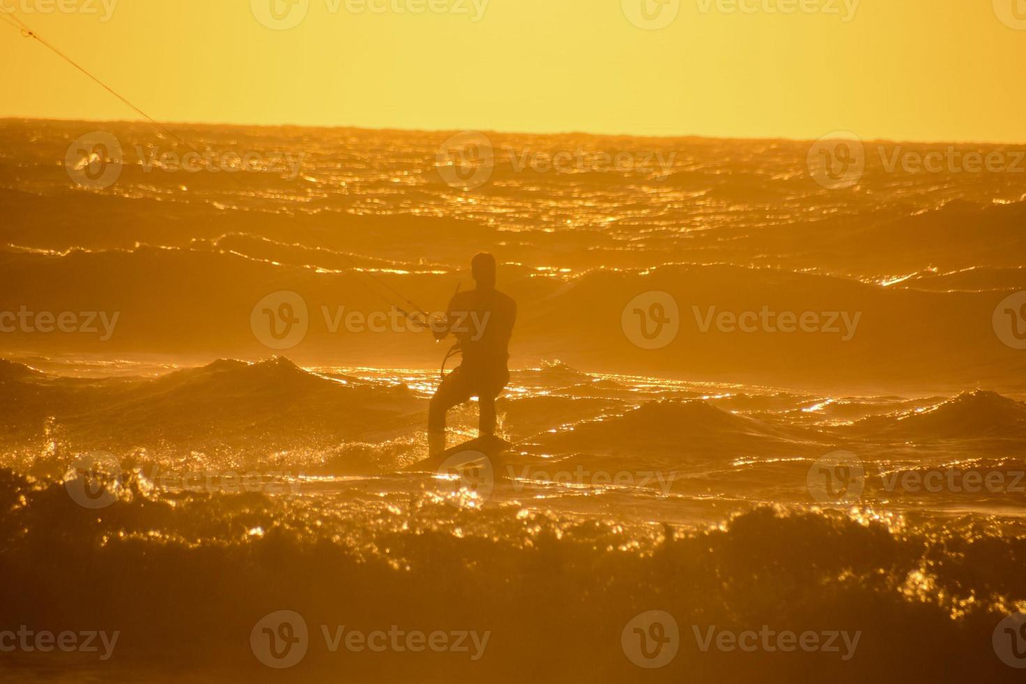 Kitesurfer at sunset photo